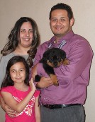 rottweiler puppy with owners